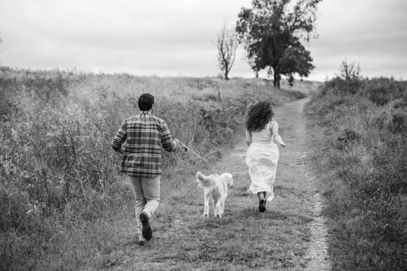candid photo of bride and groom in a field laughing