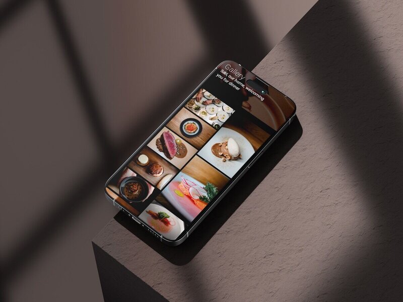Smartphone displaying mobile version of a fine dining restaurant website gallery.