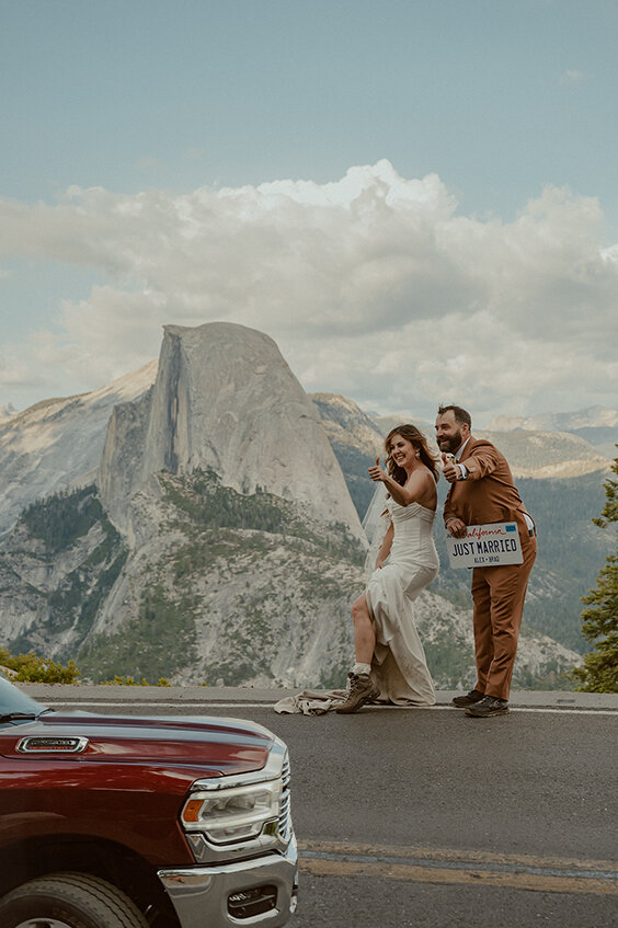 bride and groom hitchhiking in yosemite at glacier point