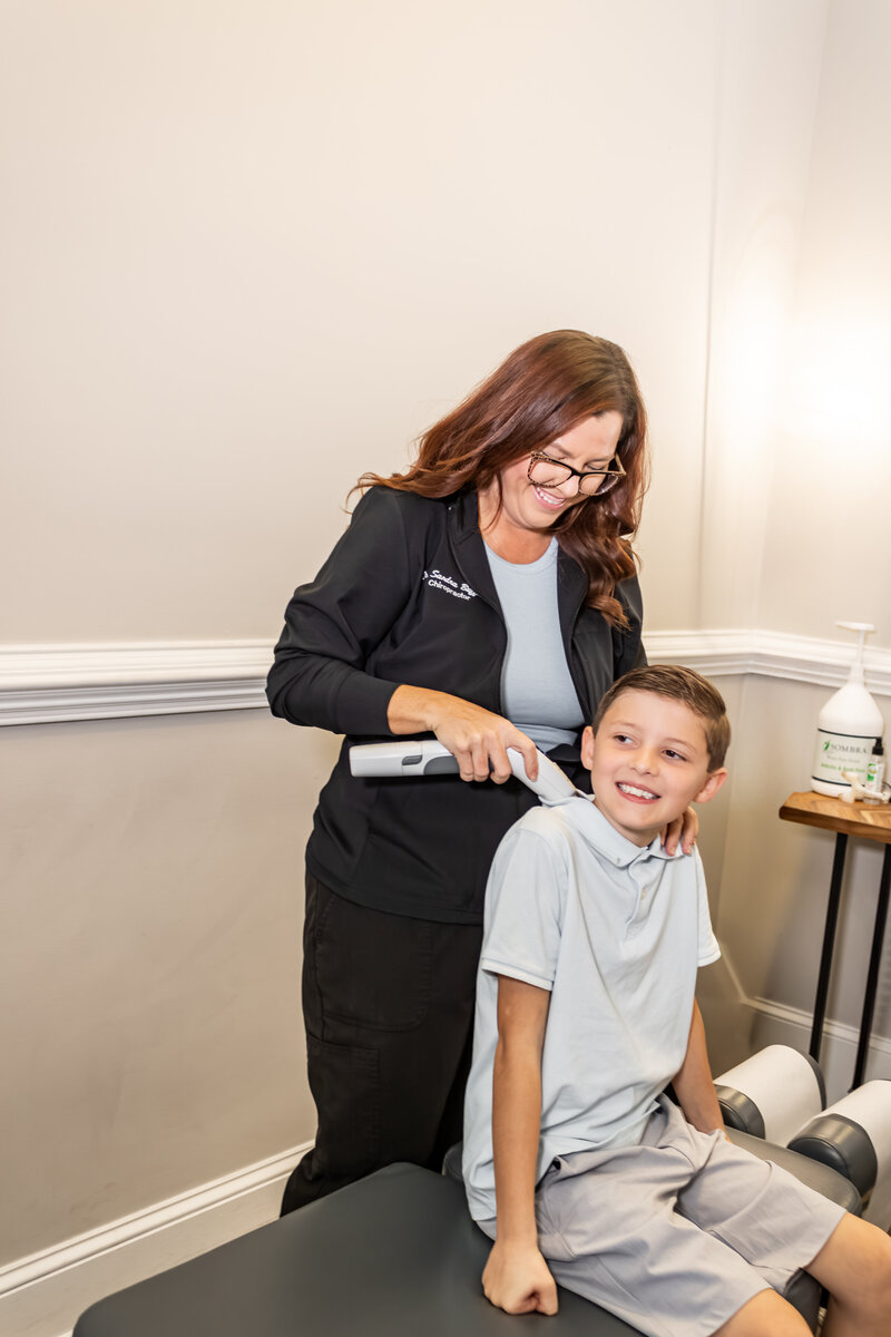 Dr. Buffkin massaging a child's shoulder