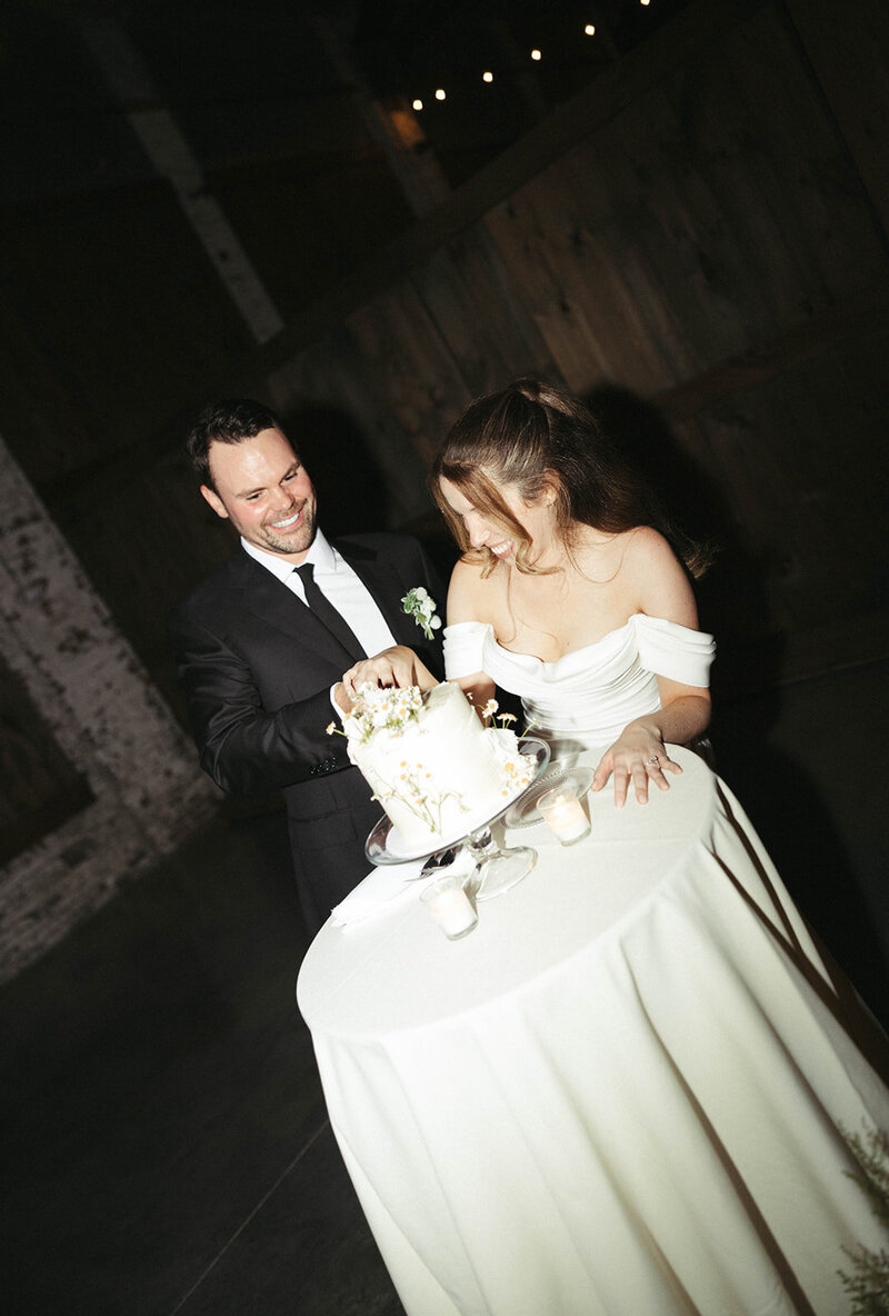 Couple celebrating their Maine Wedding with arms up in the air