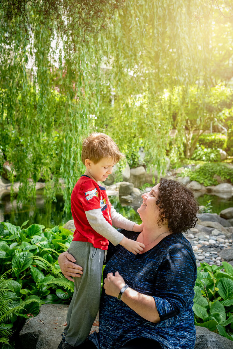 Mother and Son under a tree looking at eachother