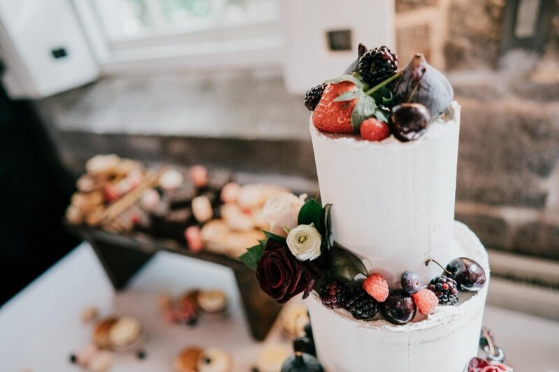 A wedding cake topped with berries