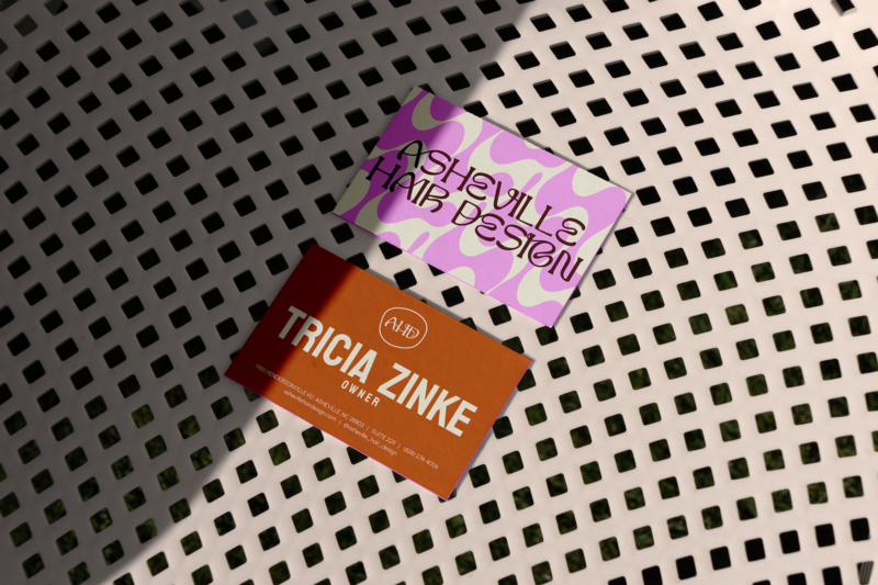 black and white checkered background with a mockup for business card for the owner of asheville hair design