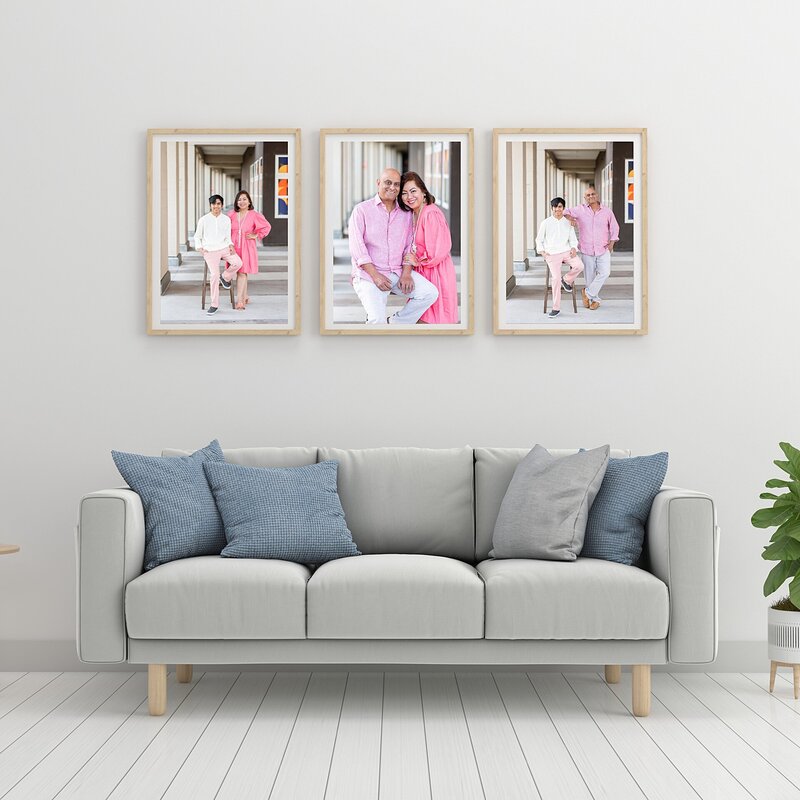 Framed portraits over a sofa