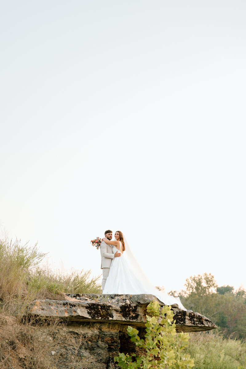 outdoor portraits of bride and groom  in national park on a rock