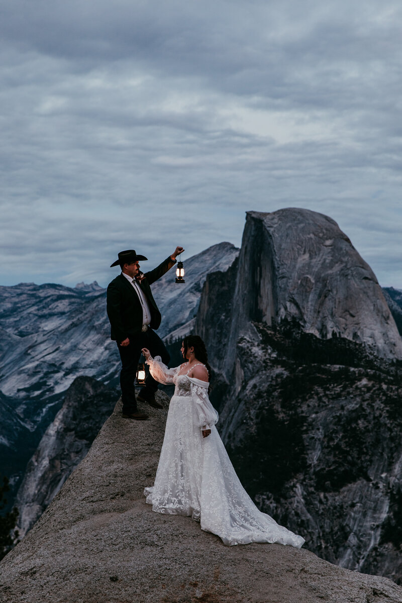 Couple dancing on a rocky overlook at Donner Summit during their Lake Tahoe elopement, surrounded by mountain views and soft sunset light over Donner Lake.