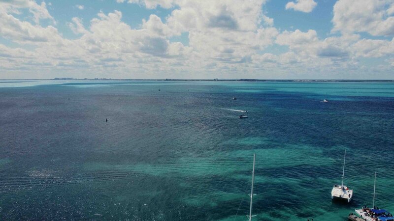 Drone view of crystal-clear ocean waters near Cancun and Isla Mujeres.