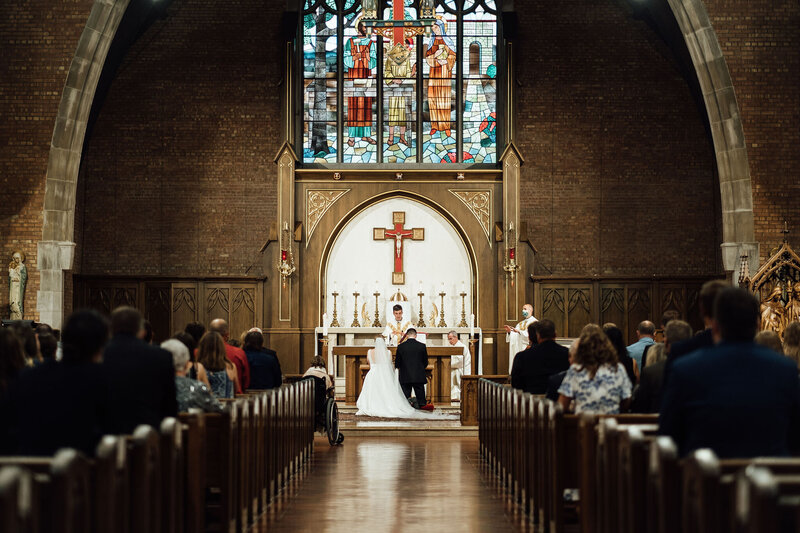 Bride and groom kneeling at the alter at their wedding ceremony