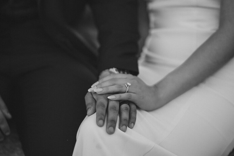 bride hand on top of groom hand