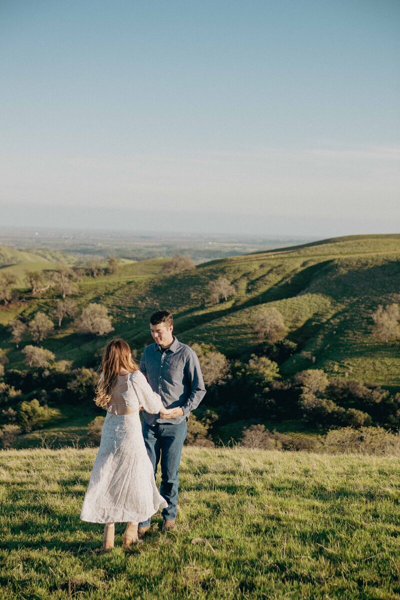 Bride and Groom embrace on a bridge