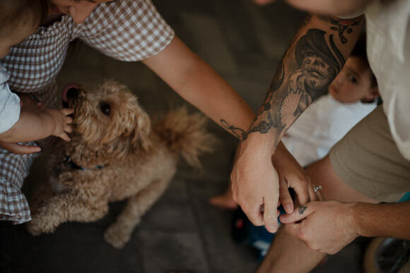 close up of woman leaning into man with her hand on his chest while he holds her