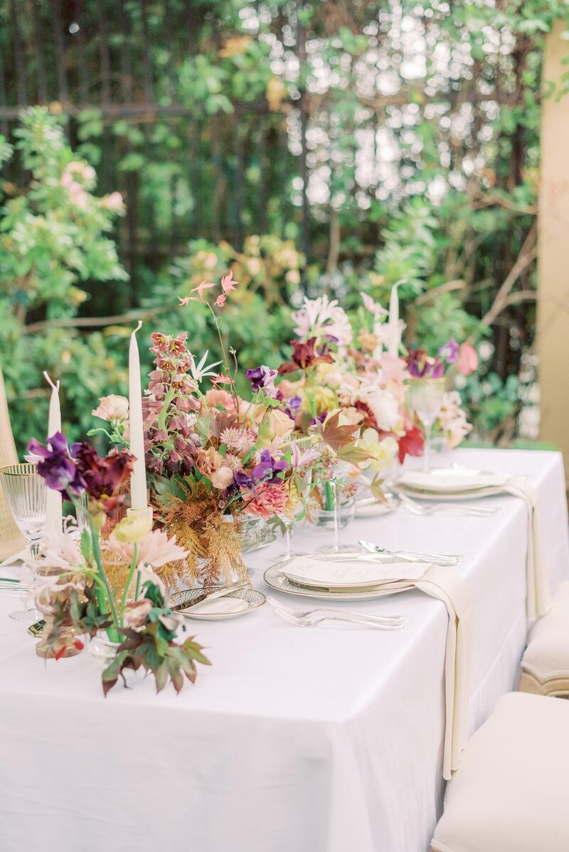 2-radiant-love-events tablescape-white-tablecloth-colorful-flowers-candles-romantic-elegant-timeless