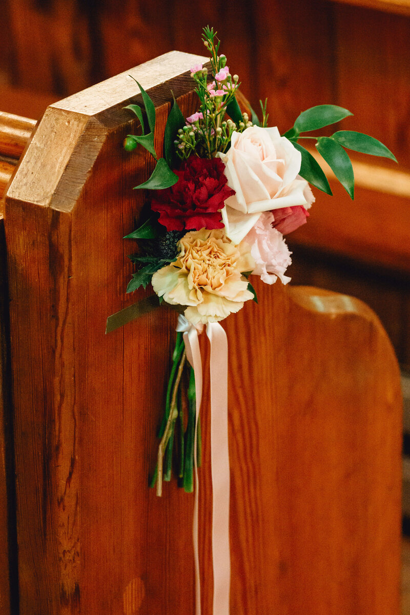 A pew end of flowers at Homme House
