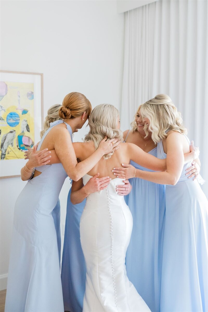 Bridesmaids hugging at their first look at the Alfond Inn, Winter Park. 