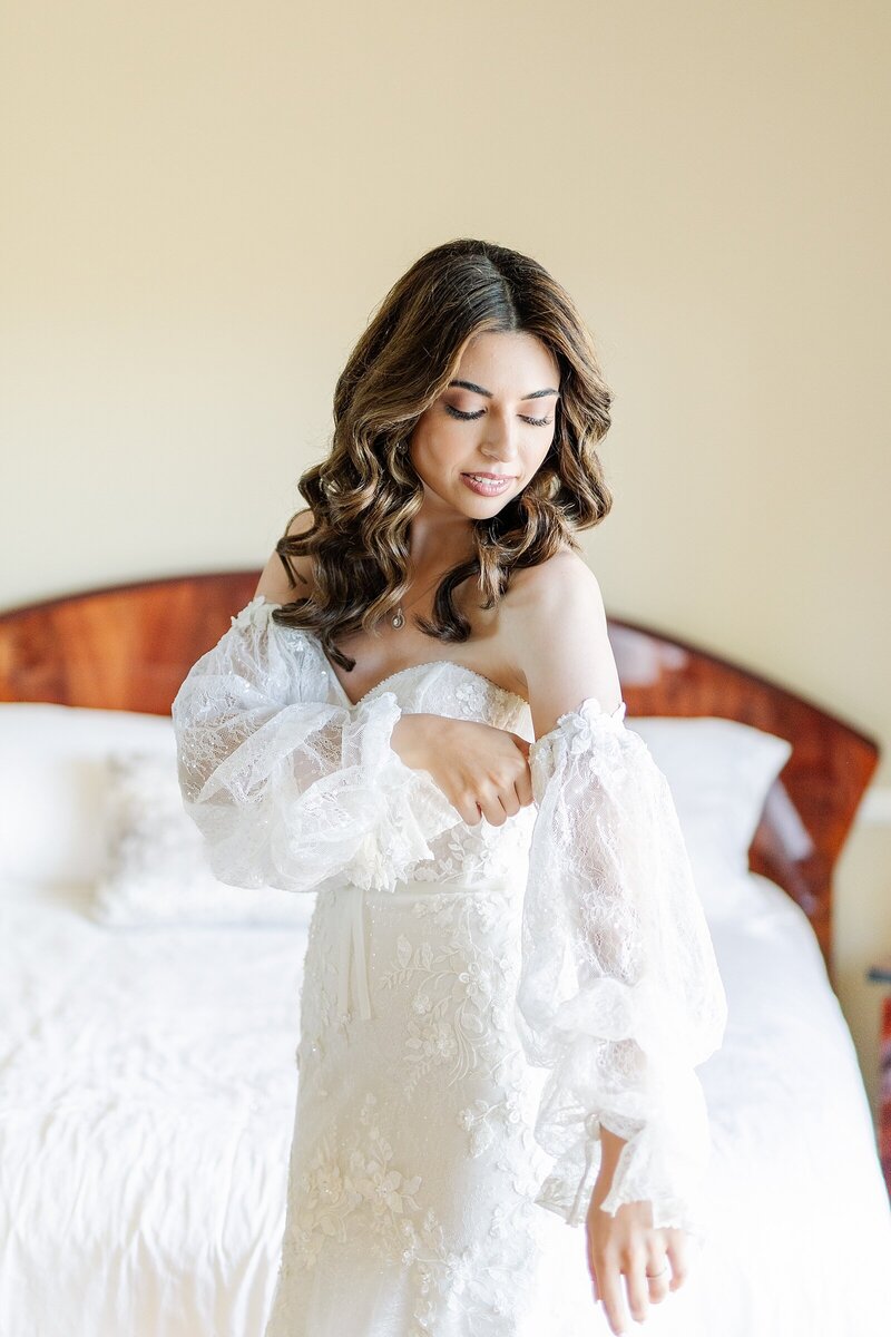 Bride adjusting her sleeves at Waldorf Astoria in Monarch Beach Resort and Club in Dana Point, California.