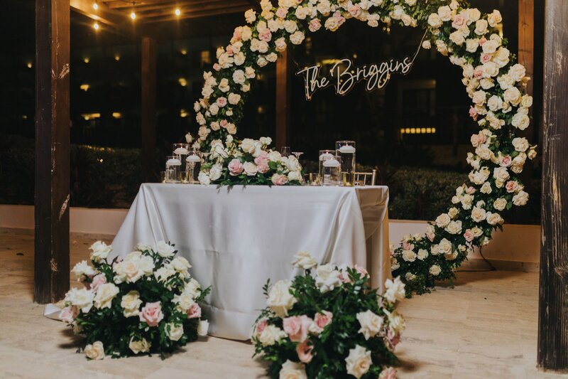 A wedding ceremony set up with flowers and a sign.