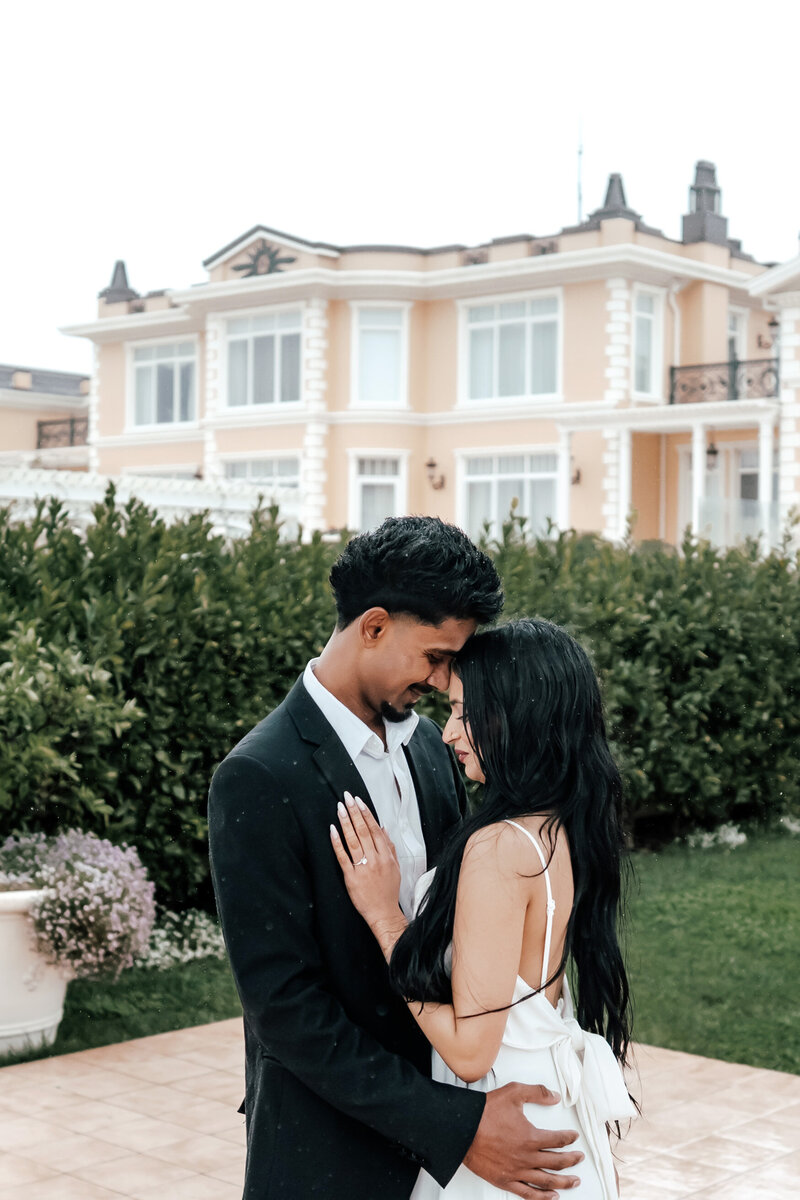 Anjali and Manvir embracing during romantic proposal at luxury estate in Auckland, photographed by Zanthe Vorsatz.