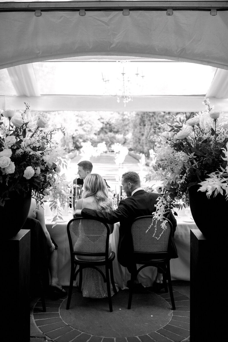 Bride and Groom Seated at Reception at Graydon Hall Manor Toronto Jacqueline James Photography