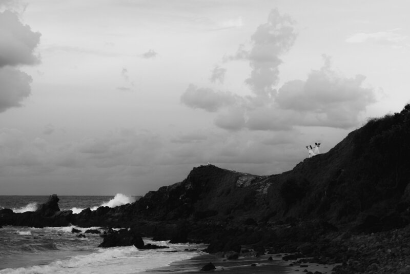 two brides on top of a cliff overlooking the rugged ocean byron bay australia  lgbtq+ally  friendly