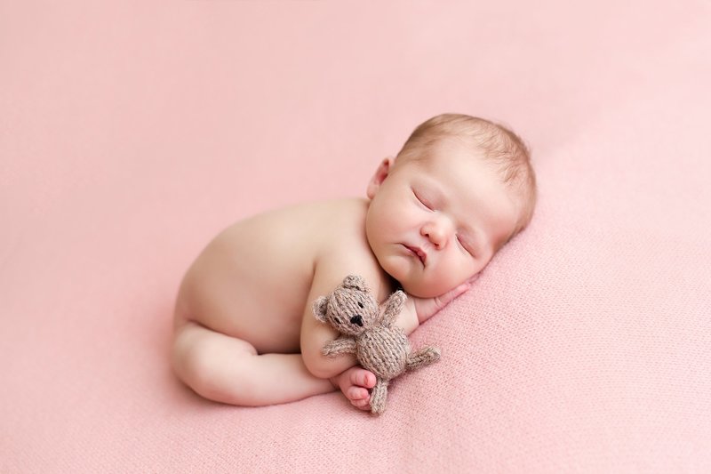 baby with tiny stuffed bear