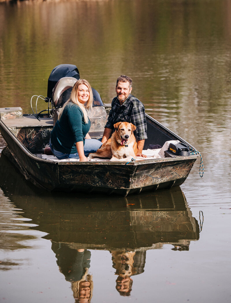 old dog with his owners in a boat