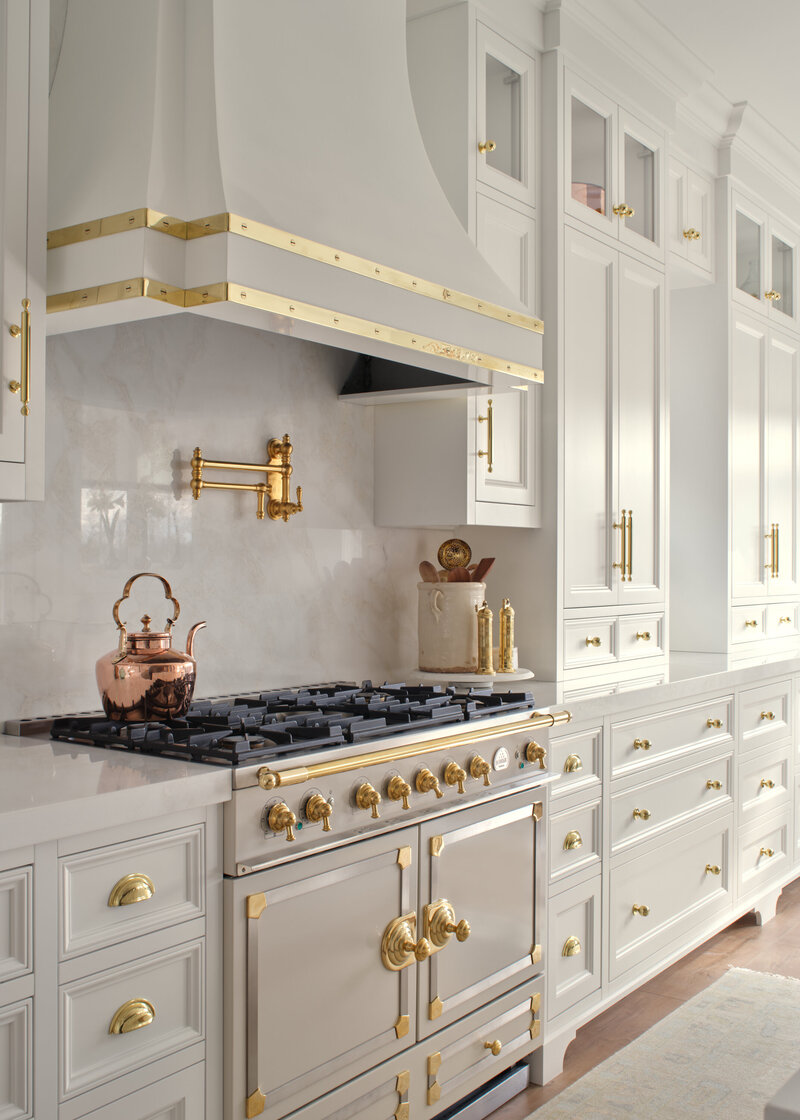 white luxury kitchen with gold accents and CornuFé  stove,