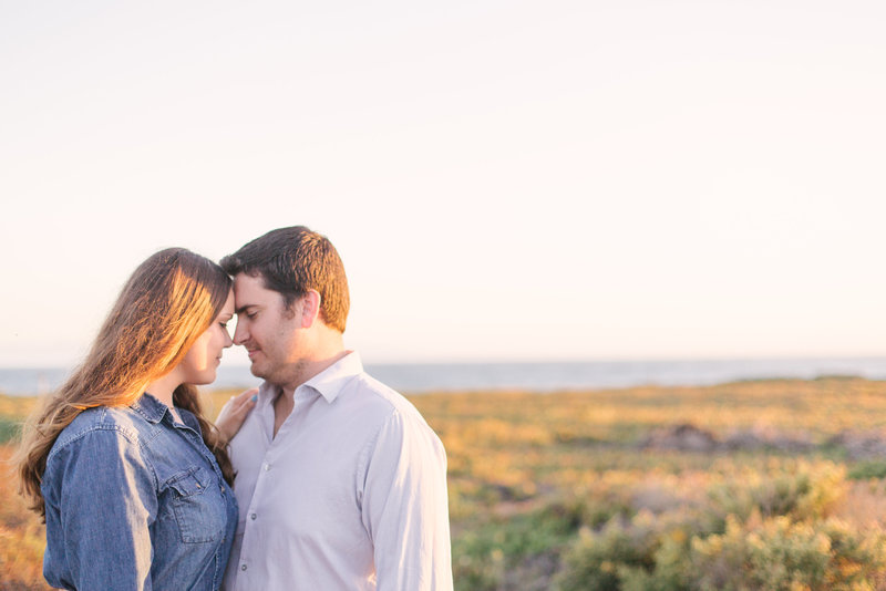 Bride and groom look at each other during  engagement shoot at UCSB