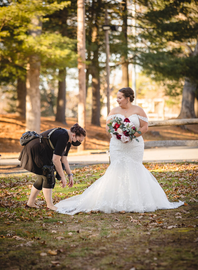 small wedding photographer helping bride