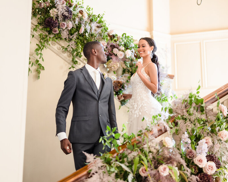 A bride and groom laugh as they exit their wedding ceremony