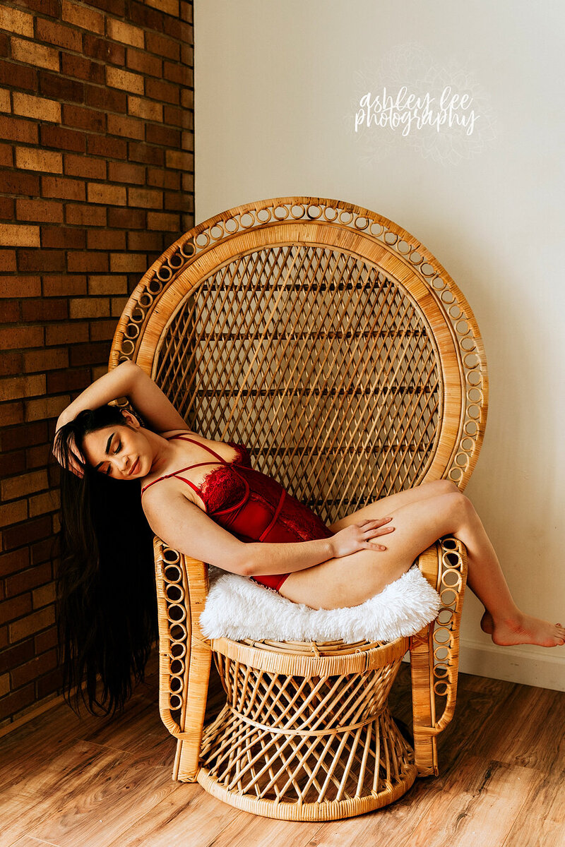 woman laying in egg chair for boudoir session