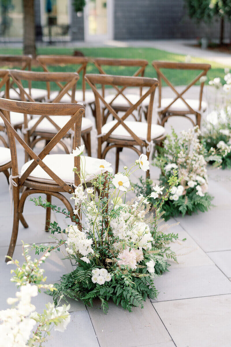 wedding aisle with chairs and flowers by wedding planner Minnesota