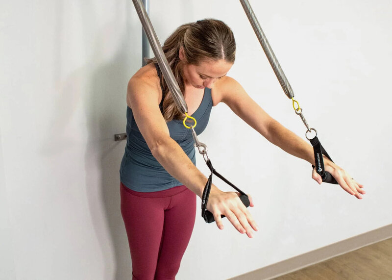 Woman doing a Classical Pilates exercise on the Ped-o-Pull