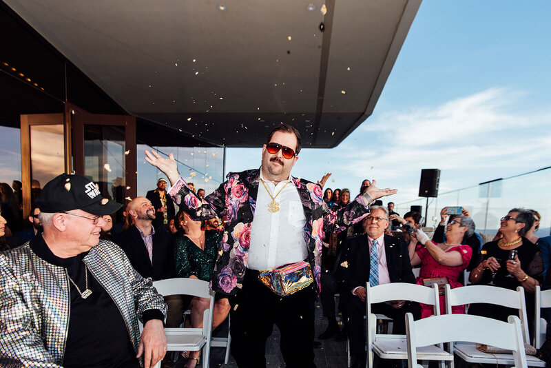 A man blowing confetti out of his hand.