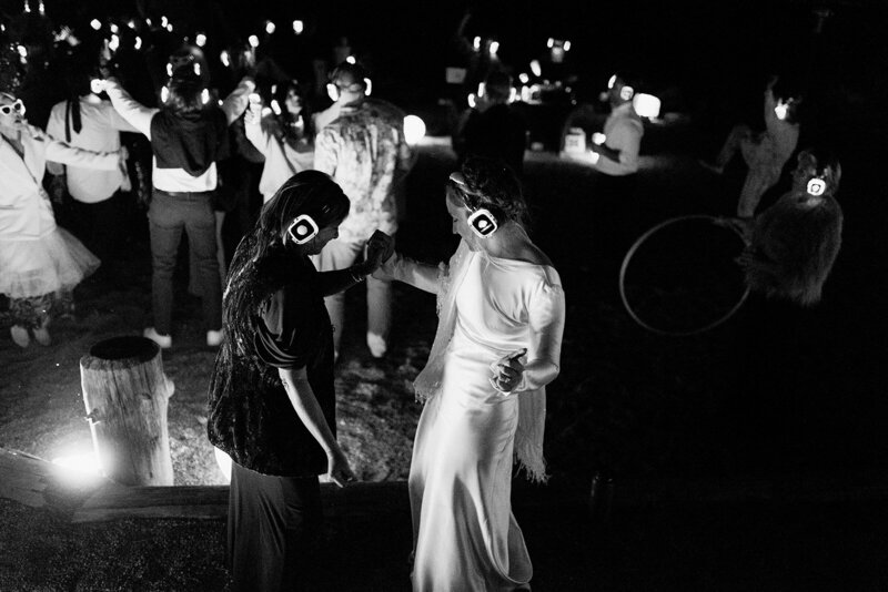 A bride and guests dancing at a silent disco reception party at a wedding planned by Perfect Thirds & Co. 