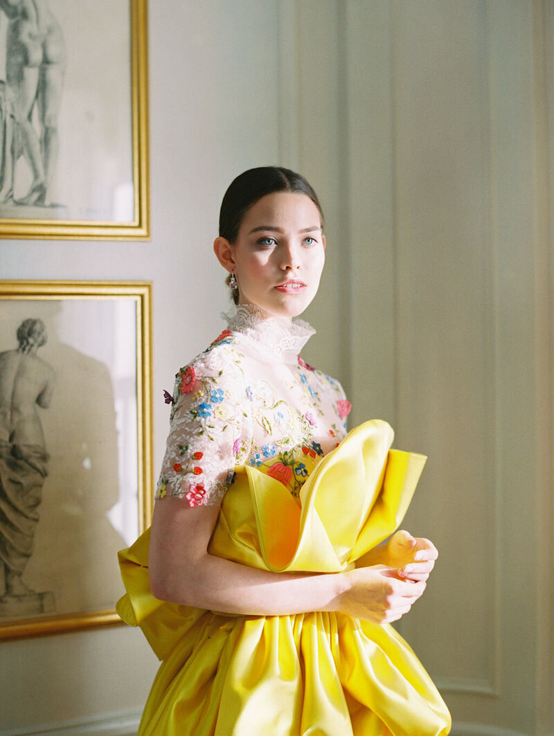 Model in embroidered dress with yellow satin skirt