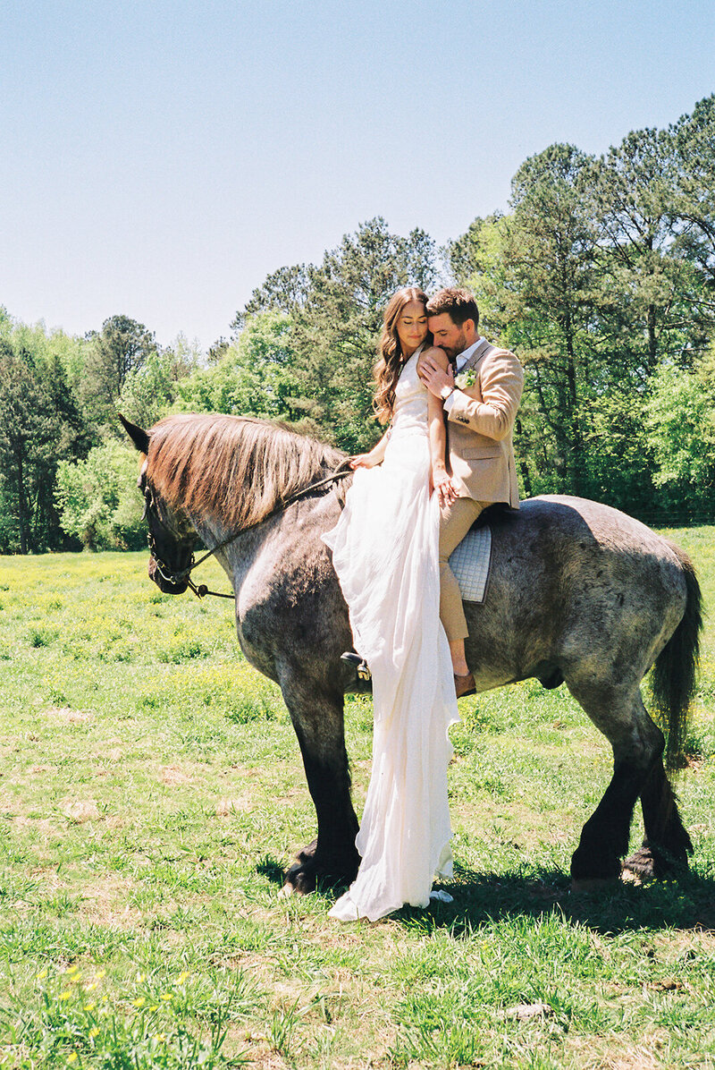 Bride and groom kissing during outdoor wedding ceremony