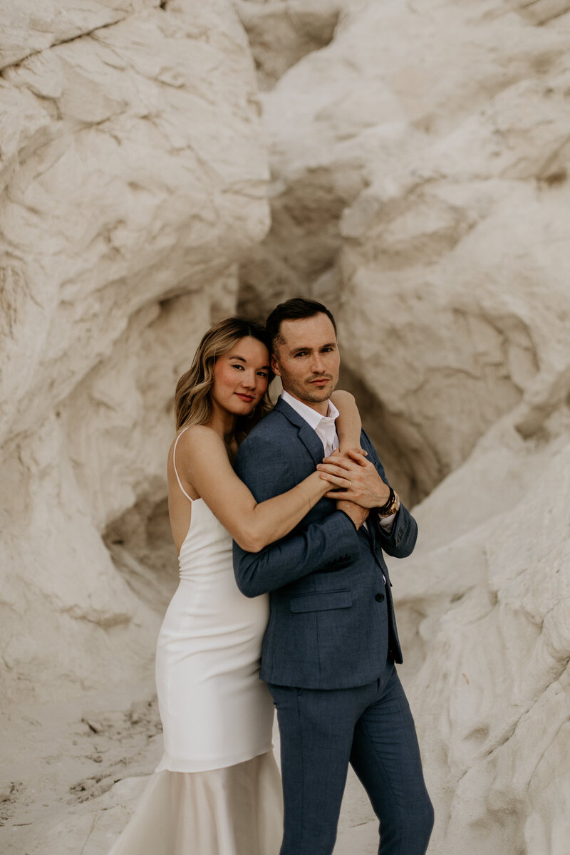 newlyweds riding on the back on a golf cart in New Mexico