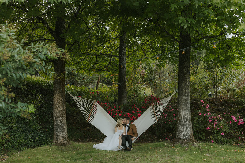 bride and groom kissing in the middle of a wedding party