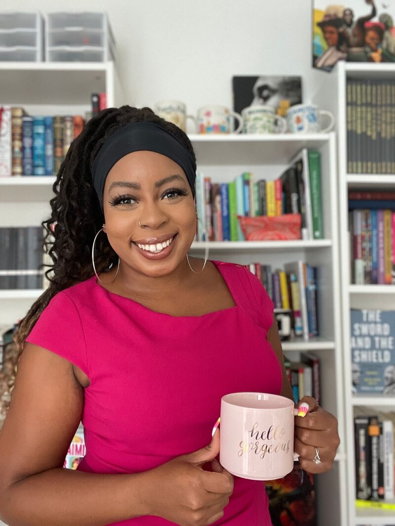 Deonna holding a coffee mug