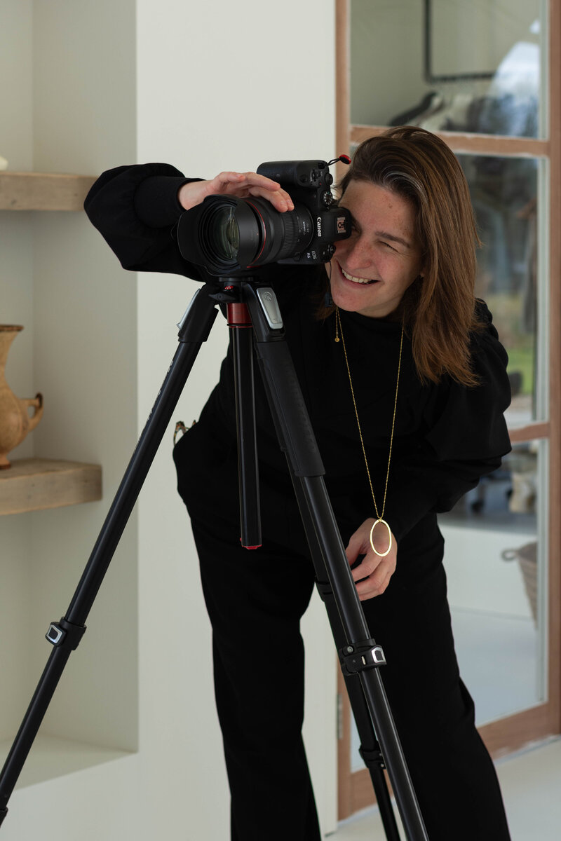 Fotograaf Dorien Paymans aan het werk in studio Loodz Mosa. Ze kijkt door Canon  camera en Manfrotto statief.