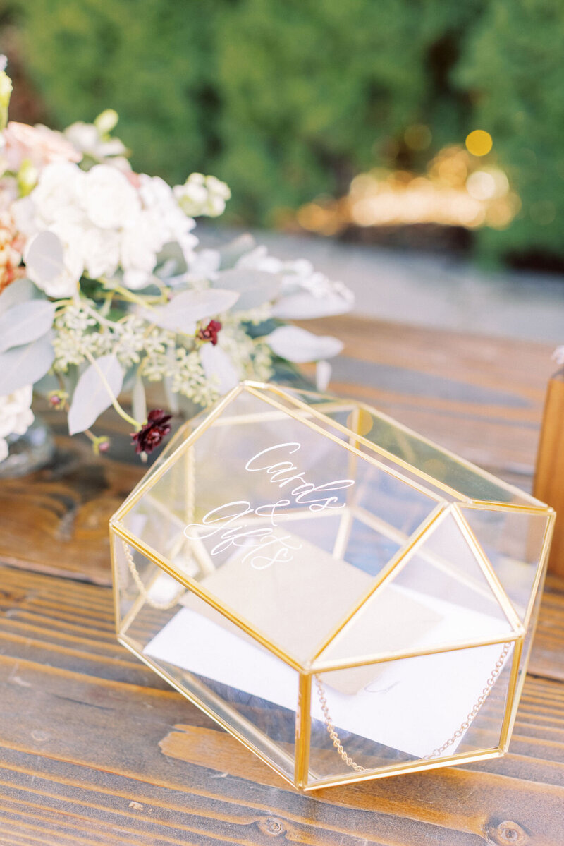 Glass and gold cards box rental with calligraphy that says cards and gifts