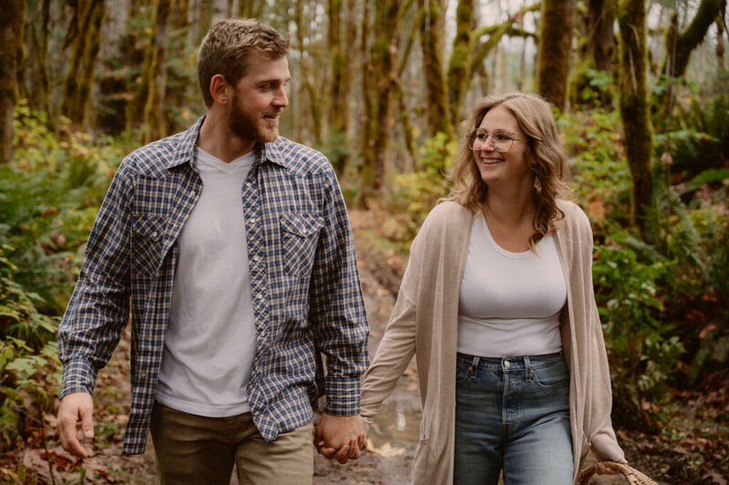 couple-holding-hands-walking-forest