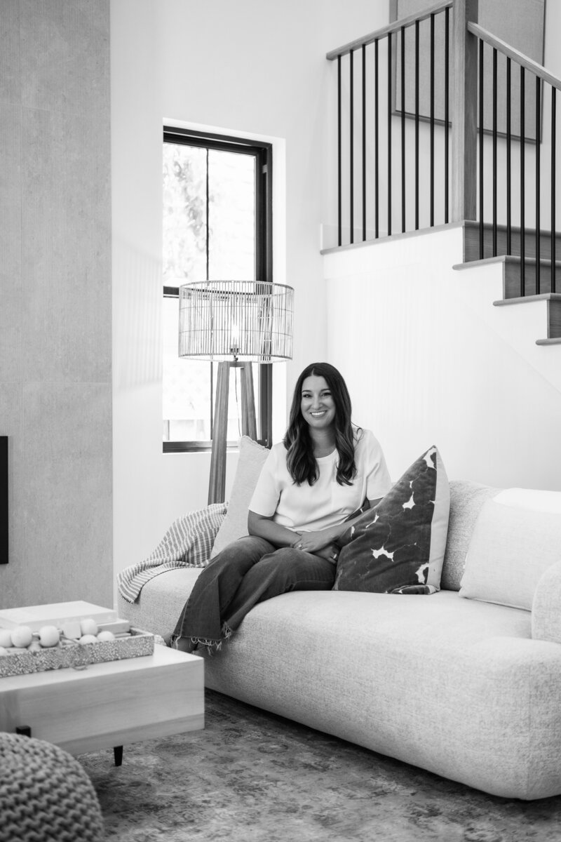 Charlene Bernhardt sitting on a couch in a new home build in Willow Glen