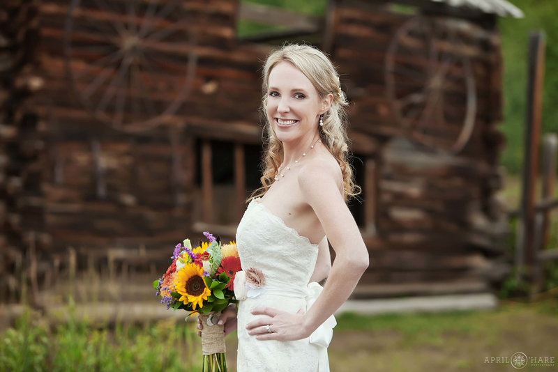 Bride portrait at Snow Mountain Ranch at Rowley Homestead with rustic log cabin backdrop