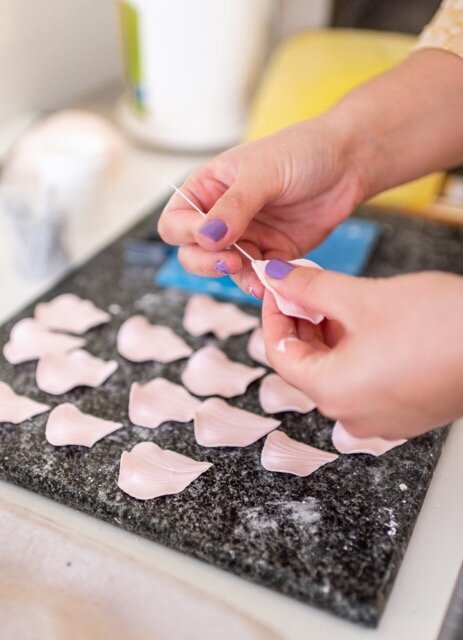 woman painting sugar flwoer