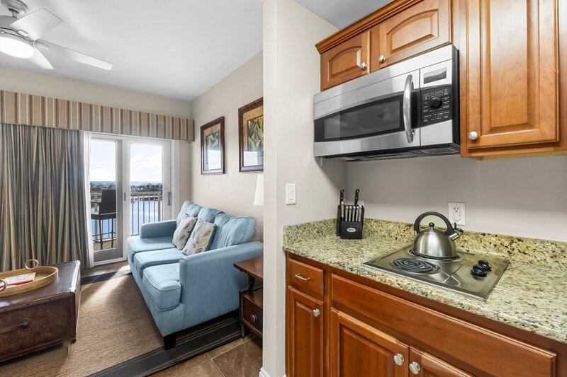 kitchentte and living room with blue sofa
