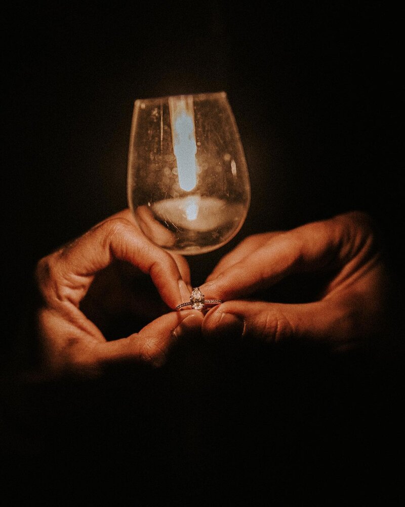 “Dark moody vintage wedding ring detail shot under Edison lightbulb, cinematic editorial film style
