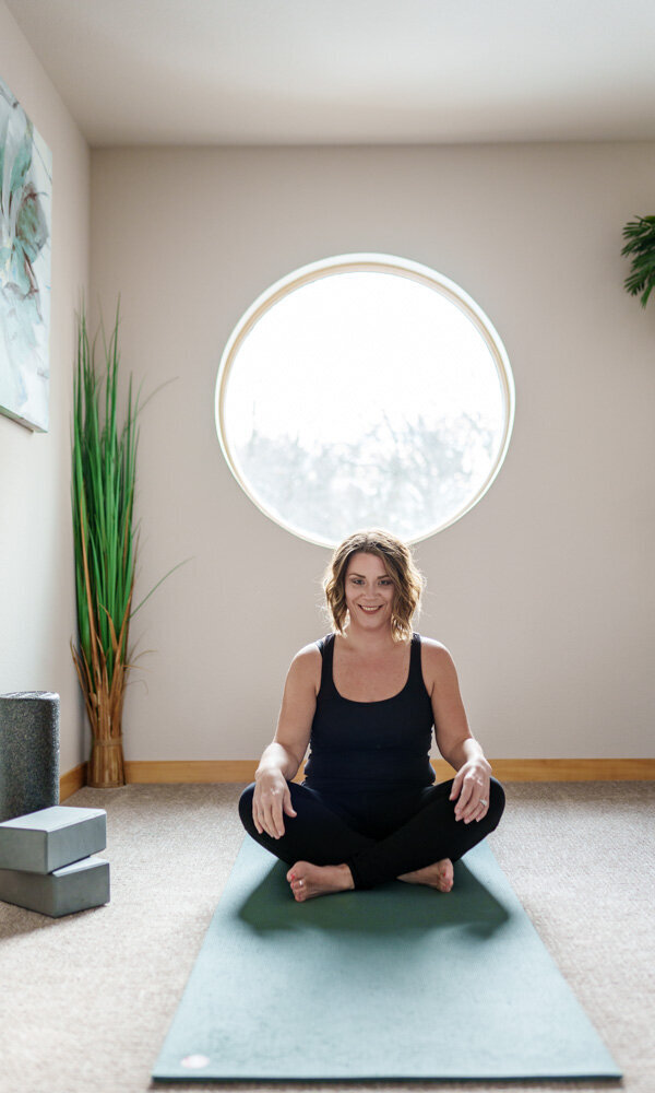 jen heller on a yoga mat under a circular window