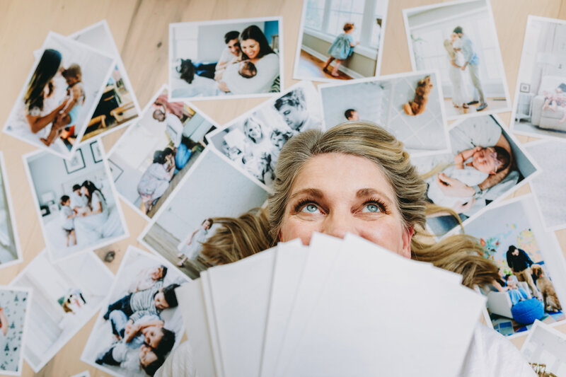 Natasha Sewell surrounded by photo prints